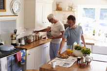 Male Gay Couple Preparing Breakfast In Their Kitchen