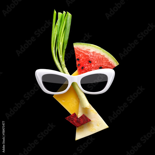 Fotografía Fruity Picasso / Quirky food concept of Picasso style female face in sunglasses made of fresh fruits on black background