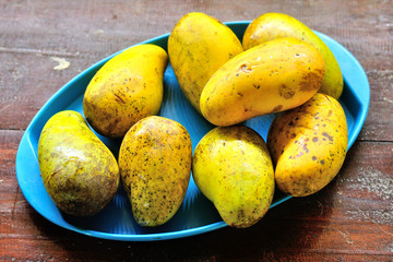 Old ripe mango on dish