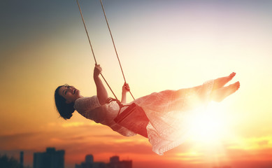 Wall Mural - young woman on a swing