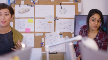 Wall Mural -  Young creative technical design team working in office with lots of computers