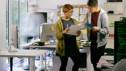 Wall Mural -  Time lapse of young computer experts working in office with lots of computers