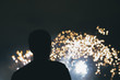 Fireworks - Silhouette of a man watching the lights in the night - Blurred fireworks