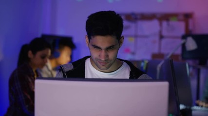 Wall Mural -  Young computer hacker trying to gain access to a computer system
