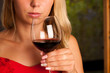 Beautiful woman drinks red wine outdoor on a hot summer afternoo