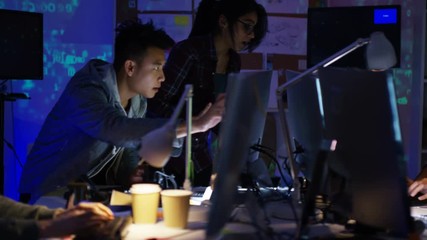 Wall Mural -  Team of young computer hackers trying to gain access to a computer system