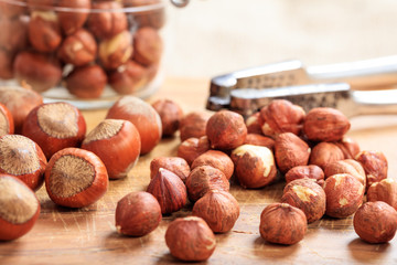 Wall Mural - Hazelnuts and a nutcracker on a table