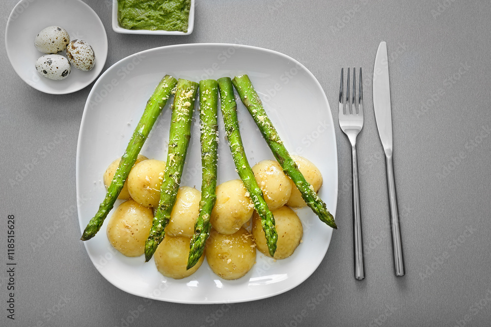 Grilled asparagus with potatoes on plate