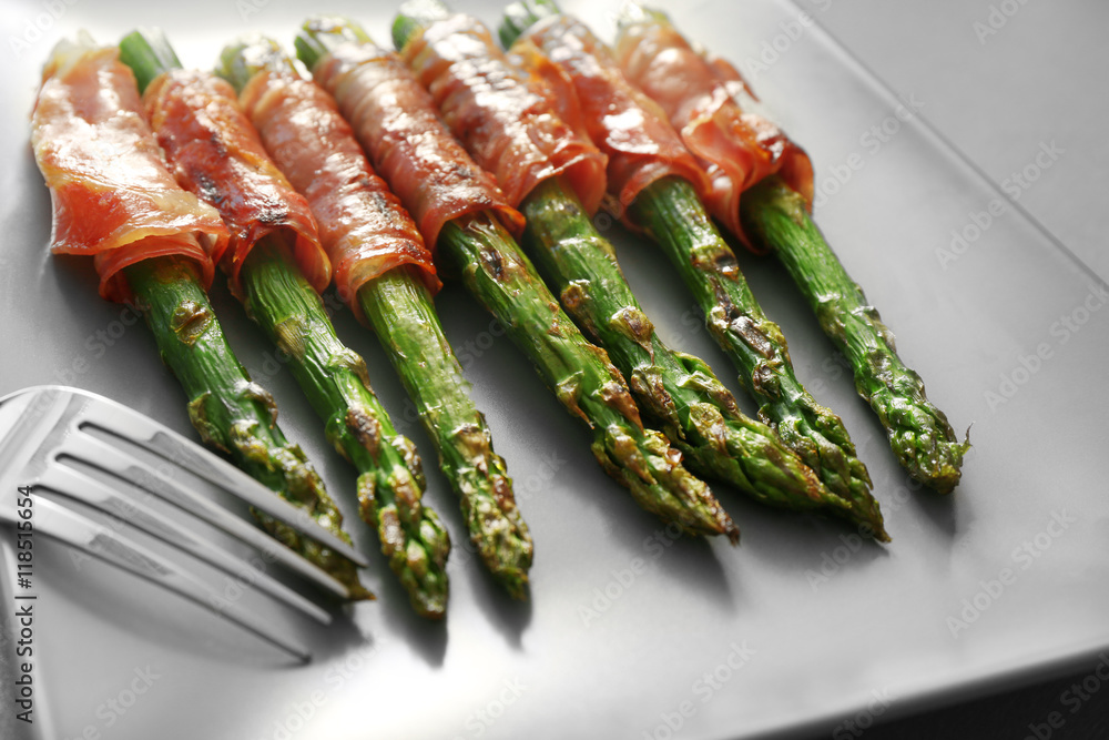 Asparagus with bacon on plate