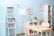 © Africa Studio - Wooden table in blue children room interior