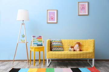 Wall Mural - Yellow sofa with toys in children room