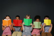 © Africa Studio - Cute kids reading books on grey background