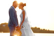 © Africa Studio - Groom and bride on sunset background