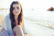 © patramansky - Young thoughtful woman at the beach looking camera