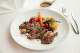 Fototapeta Kuchnia -  cooked rare sirloin steak  on a white plate