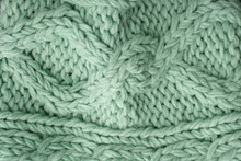A Full Page Close Up Of Pastel Green Knitted Sweater Fabric Texture