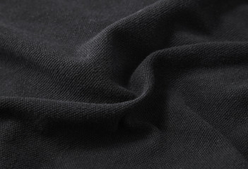 A full page close up of black fabric texture