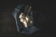 Bunch of garlic with napkin on the wooden table top view