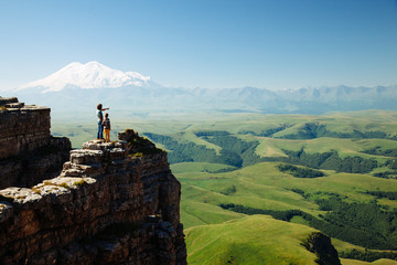 Wall Mural - Travelers looking to Elbrus mountain