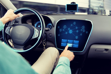 Canvas Print - close up of man driving car with on board computer