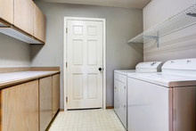 Laundry Room With Washer And Dryer With Tile Floor.
