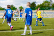 © matimix - Football game between youth teams. Young boys playing soccer match on the sports field