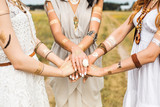 Fototapeta Boho - Close-up of female hands, three girls, best friends, flash tattoo, accessories, Bohemian, boho style, indie hippie, ring, bracelet, manicure, feathers
