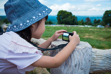 Wall Mural - Side view of asian girl relaxing outdoors in the day time, travel on vacation