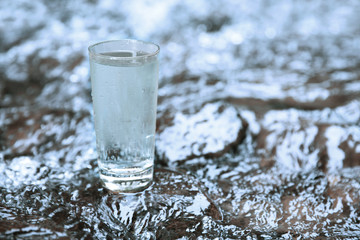 Wall Mural - Glass of water on water background