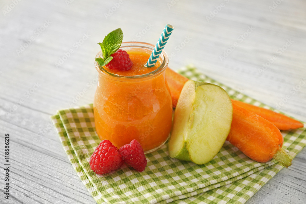 Tasty smoothie drink with vegetables and fruits on table
