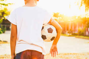 kids are playing soccer football for exercise in the evening.