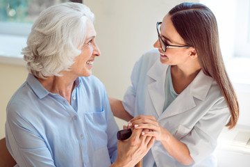 Young nurse helping senior patient