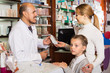 © JackF - Pharmacist helping customers
