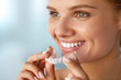 © puhhha - Smiling Woman With White Teeth Holding Teeth Whitening Tray. High Resolution Image