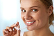 © puhhha - Smiling Woman With White Teeth Holding Teeth Whitening Tray. High Resolution Image