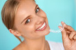 © puhhha - Smiling Woman With White Teeth Holding Teeth Whitening Tray. High Resolution Image