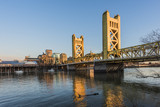 Fototapeta Krajobraz - Gold Tower Bridge, in Sacramento California during blue sunset with downtown and goose
