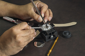 watchmaker will repair watch with his tools