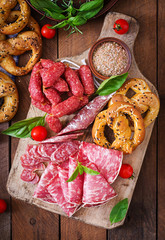 Wall Mural - Pretzels and various sausages on wooden background. Oktoberfest.