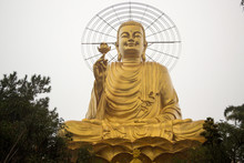 Golden Buddha Statue Under Rain In The City Of Dalat In Vietnam