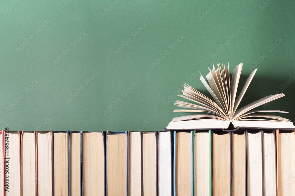 Open book, hardback books on wooden table. Education background. Back to school. Copy space for text.