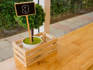 eight number made from wooden, vintage style on the table in coffee shops.
