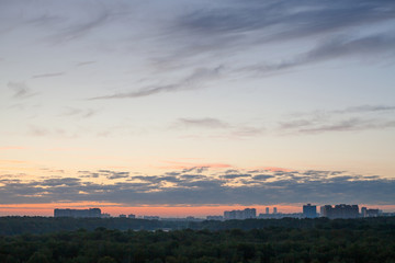 Canvas Print - blue sky with pink horizon over city