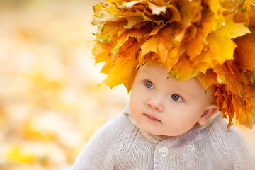 Little boy in autumn orange leaves. Outdoor.