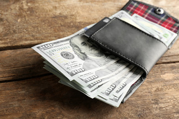 Wall Mural - Leather wallet with money on wooden table