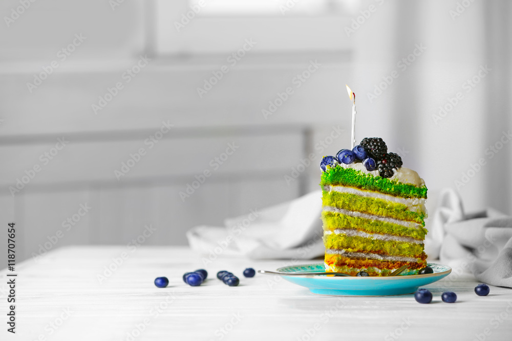 Delicious cake slice with candle on light background