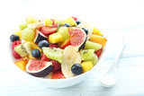 Fototapeta  - Fresh fruit salad on a white wooden table