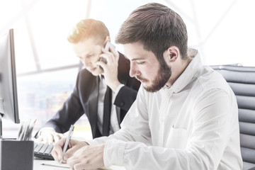 Colleagues working in firm office