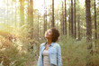 © pablocalvog - Young girl looking up into the trees