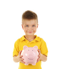 Poster - Savings concept. Cute boy in yellow T-shirt holding piggy bank isolated on white